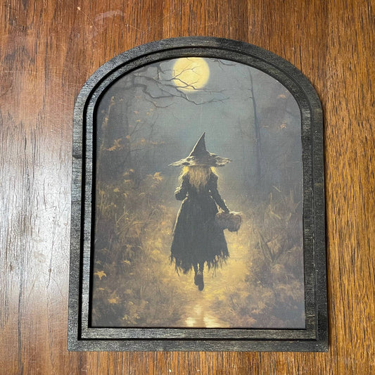 Witch walking in moonlight in small arch
