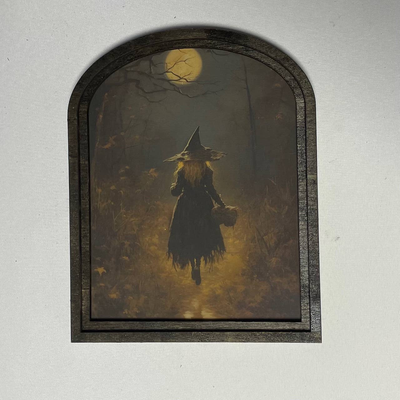 Witch walking in moonlight in small arch